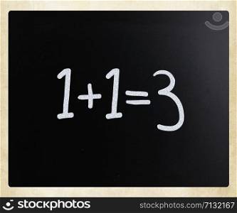 1+1=3 handwritten with white chalk on a blackboard