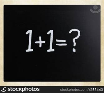 ""1+1=?" handwritten with white chalk on a blackboard"