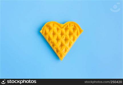 1 Piece Heart Shape Waffle on Blue Pastel Background Minimalist Style. Heart shape waffle dessert in minimalist style for food and dessert category
