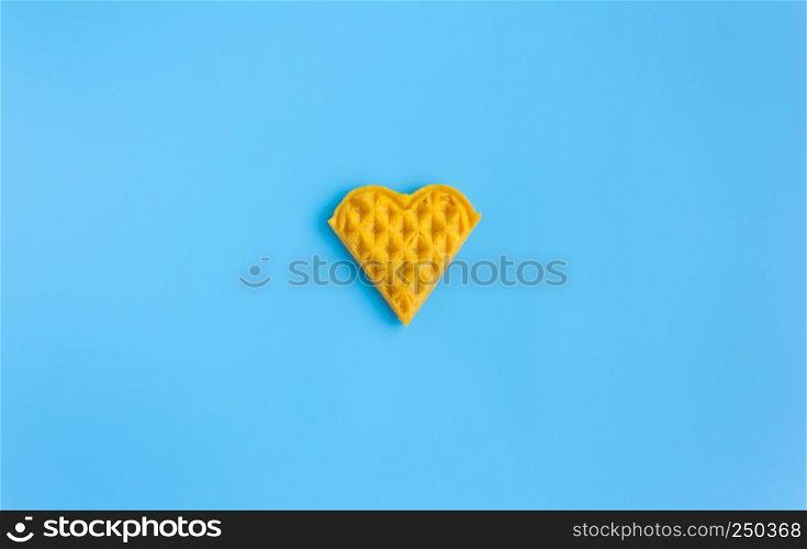 1 Piece Heart Shape Waffle on Blue Pastel Background Minimalist Style Wide Angle. Heart shape waffle dessert in minimalist style for food and dessert category