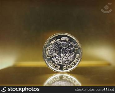 1 pound coin, United Kingdom over gold. 1 pound coin money (GBP), currency of United Kingdom over golden background