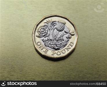 1 pound coin, United Kingdom over gold. 1 pound coin money (GBP), currency of United Kingdom over golden background