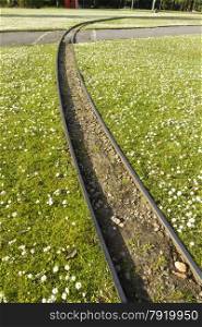 10.25 inch gauge miniature railway railroad, across grass. Poole Park, Dorset, England United Kingdom.