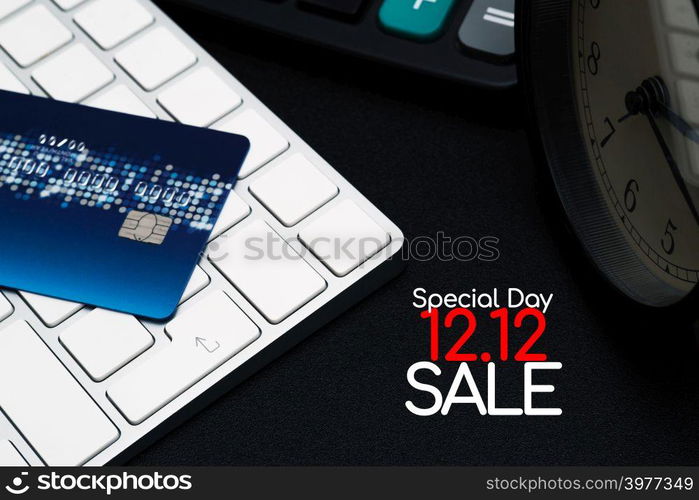 12.12 sale concept, closeup credit card on black enter button, convenience shopping concept