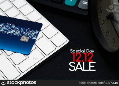 12.12 sale concept, closeup credit card on black enter button, convenience shopping concept
