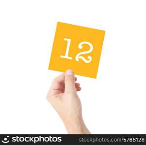 12 written on a card held by a hand