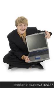 15 year old teen boy in suit pointing to computer screen.