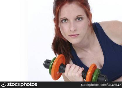 17 year old girl with long red hair over white holding hand weights