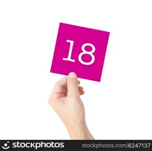 18 written on a card held by a hand