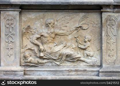 18th century bas-relief of the Chronos (God in Greek mythology, personification of Time) by Johann Heinrich Meissner on the historic tenement house terrace in the Old Town of Gdansk, Poland