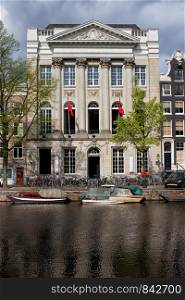 18th century Neoclassical Felix Meritis building by the Kaizersgracht canal in Amsterdam, Netherlands.