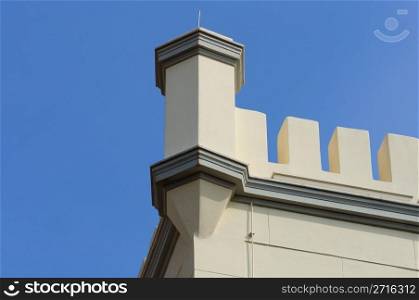 19th century building with decorative tower battlements. Architectural detail.