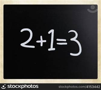 ""2+1=3" handwritten with white chalk on a blackboard"