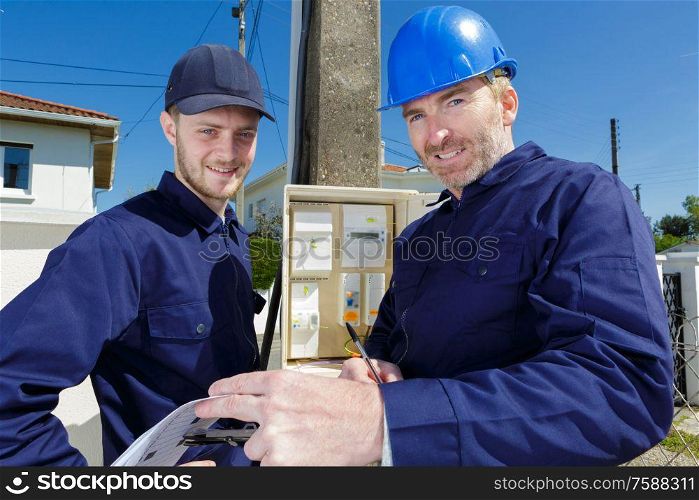 2 maletechnician looking at camera