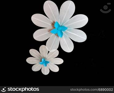 2 metal flowers with a black background