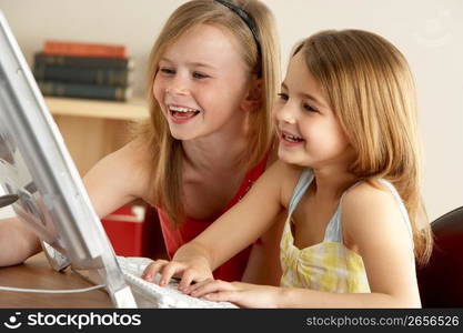 2 Young Girls Using Computer At Home