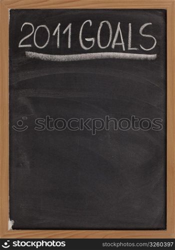 2011 goals title handwritten with white chalk on blackboard with copy space below for New Year tasks and resolutions