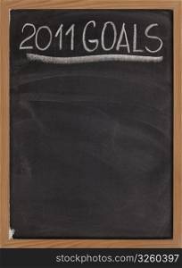 2011 goals title handwritten with white chalk on blackboard with copy space below for New Year tasks and resolutions