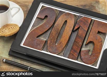 2015 - New Year concept - isolated text in vintage wood type printing blocks on a digital tablet with a cup of coffee