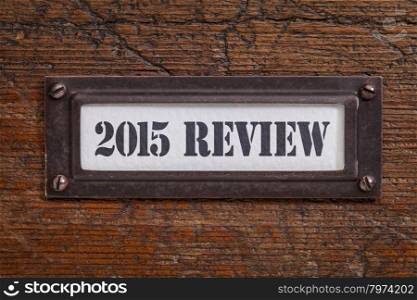 2015 review - a label on wgrunge wooden file cabinet. A passing year summary and review concept.