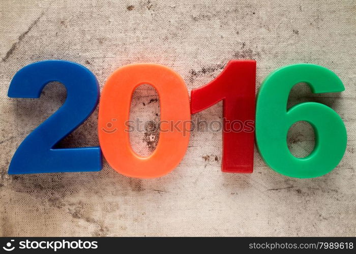 2016 colorful plastic number on the old canvas background