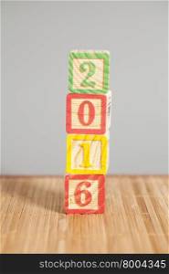 2016 New Year wooden cubes on wooden background