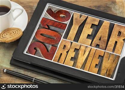 2016 review banner - annual review or summary of the recent year - word abstract in vintage letterpress wood type blocks on a digital tablet with coffee