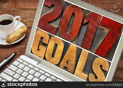2017 goals banner - New Year resolution concept - text in vintage letterpress wood type printing blocks stained by red ink on a laptop screen with a cup of coffee