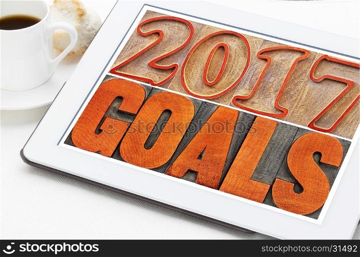 2017 goals banner - New Year resolution concept - text in vintage letterpress wood type printing blocks on a digital tablet with a cup of coffee