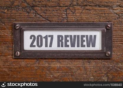2017 review - a label on grunge wooden file cabinet. A passing year summary and review concept.