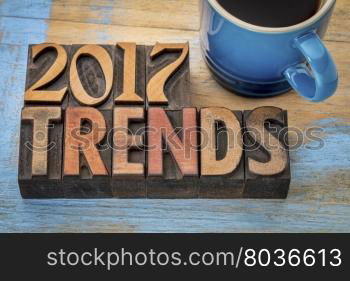 2017 trends banner - text in vintage letterpress wood type printing blocks with a cup od coffee