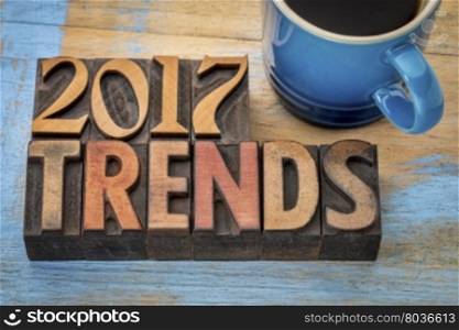 2017 trends banner - text in vintage letterpress wood type printing blocks with a cup od coffee