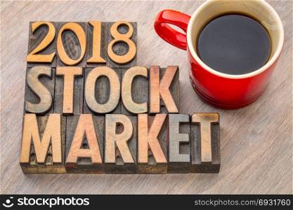 2018 stock market word abstract in vintage letterpress wood type with a cup of coffee