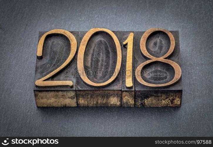 2018 year in letterpress wood type blocks against gray slate stone