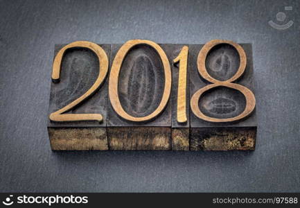 2018 year in letterpress wood type blocks against gray slate stone