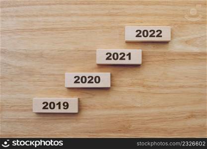 2019 to 2022 happy new year on wood block on wood table background. new year concept