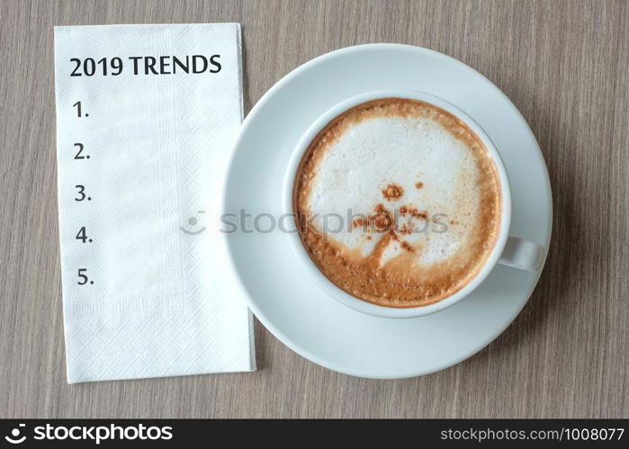 2019 TRENDS word with hot cappuccino coffee cup on table background at the morning. New Year New Start, Resolution, Solution, Strategy and Mission concept