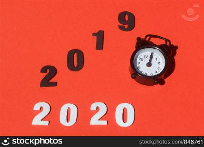 2020, 2019 and black alarm clock for new year