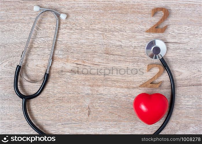 2020 Happy New Year for healthcare, Wellness and medical concept. Stethoscope with red heart and wooden number on table background