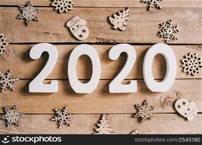 2020 New year concept on wood table and christmas decoration background.