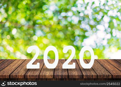 "2020 New Year concept - wooden word " 2020 " on table and blur green light background"