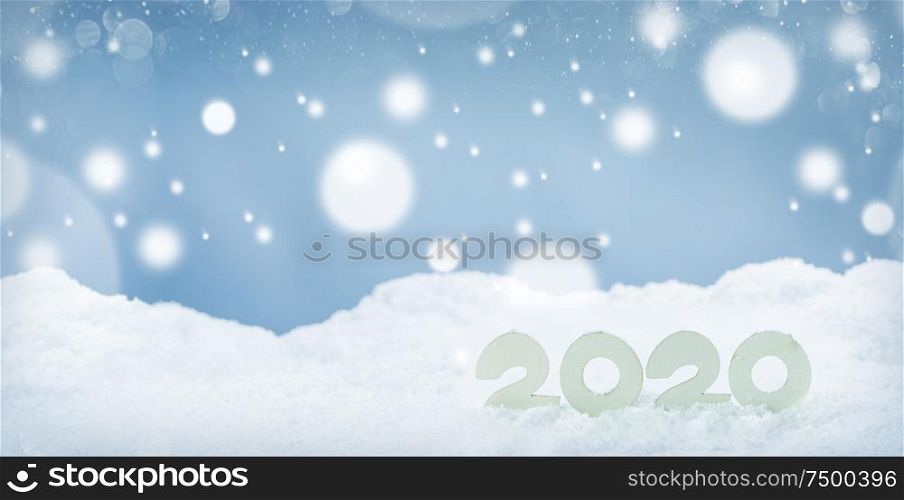 2020 New Year design concept. Wooden 2020 New Year horizontal template on snow on white bokeh backgound. 2020 New Year on snow