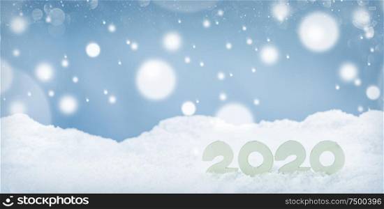2020 New Year design concept. Wooden 2020 New Year horizontal template on snow on white bokeh backgound. 2020 New Year on snow