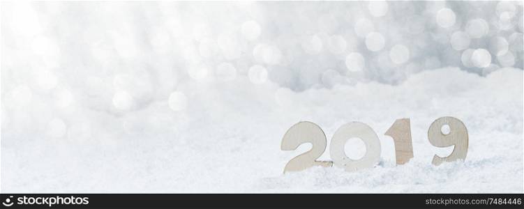 2020 New Year in snow design concept. Wooden 2020 New Year horizontal template with silver glitter backgound. 2019 New Year in snow