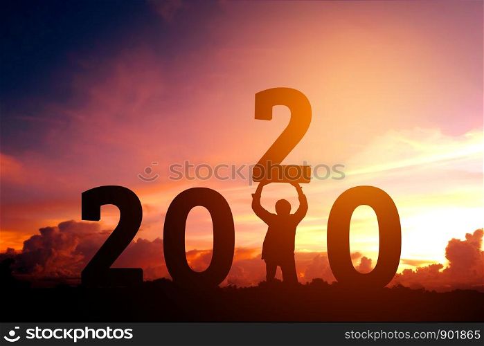 2020 Newyear Man tries to Lift up number of 2020 Happy new year concept