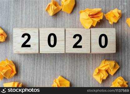 2020 text wood cube and crumbled paper on wooden table background. New Year New Ideas, Creative, Innovation, Imagination, inspiration, Resolution, Strategy and goal concept