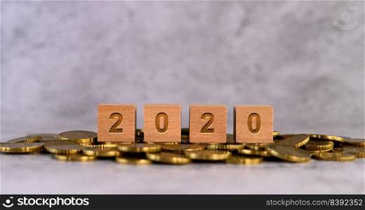 2020 word alphabet wooden cube letters placed on a gold coin