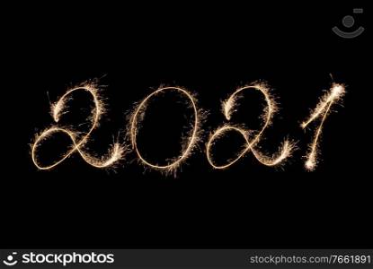 2021 New Year inscription with sparklers on a black background.. 2021 New Year inscription with sparklers .