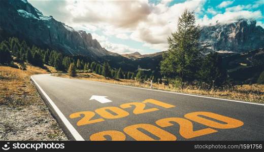 2021 New Year road trip travel and future vision concept . Nature landscape with highway road leading forward to happy new year celebration in the beginning of 2021 for fresh and successful start .