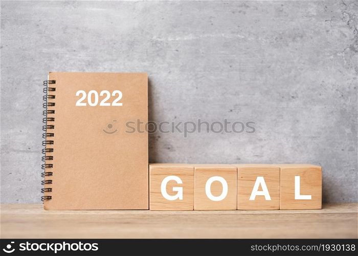 2022 calendar with GOAL block on wood table. Happy New Year, motivation, Resolution, To do list, start, Strategy and Plan concept